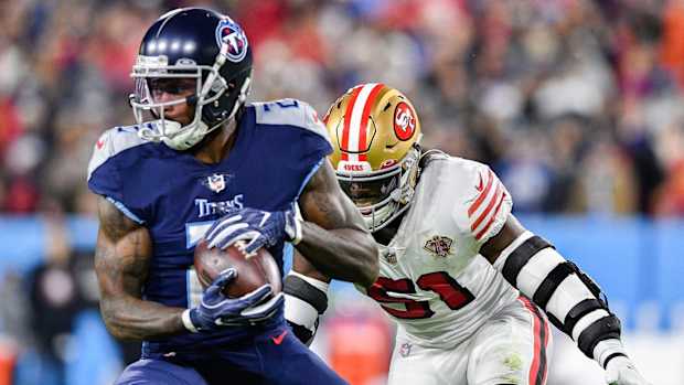 Tennessee Titans wide receiver Julio Jones (2) pulls in a catch past San Francisco 49ers linebacker Azeez Al-Shaair (51) during the first quarter at Nissan Stadium Thursday, Dec. 23, 2021 in Nashville, Tenn.